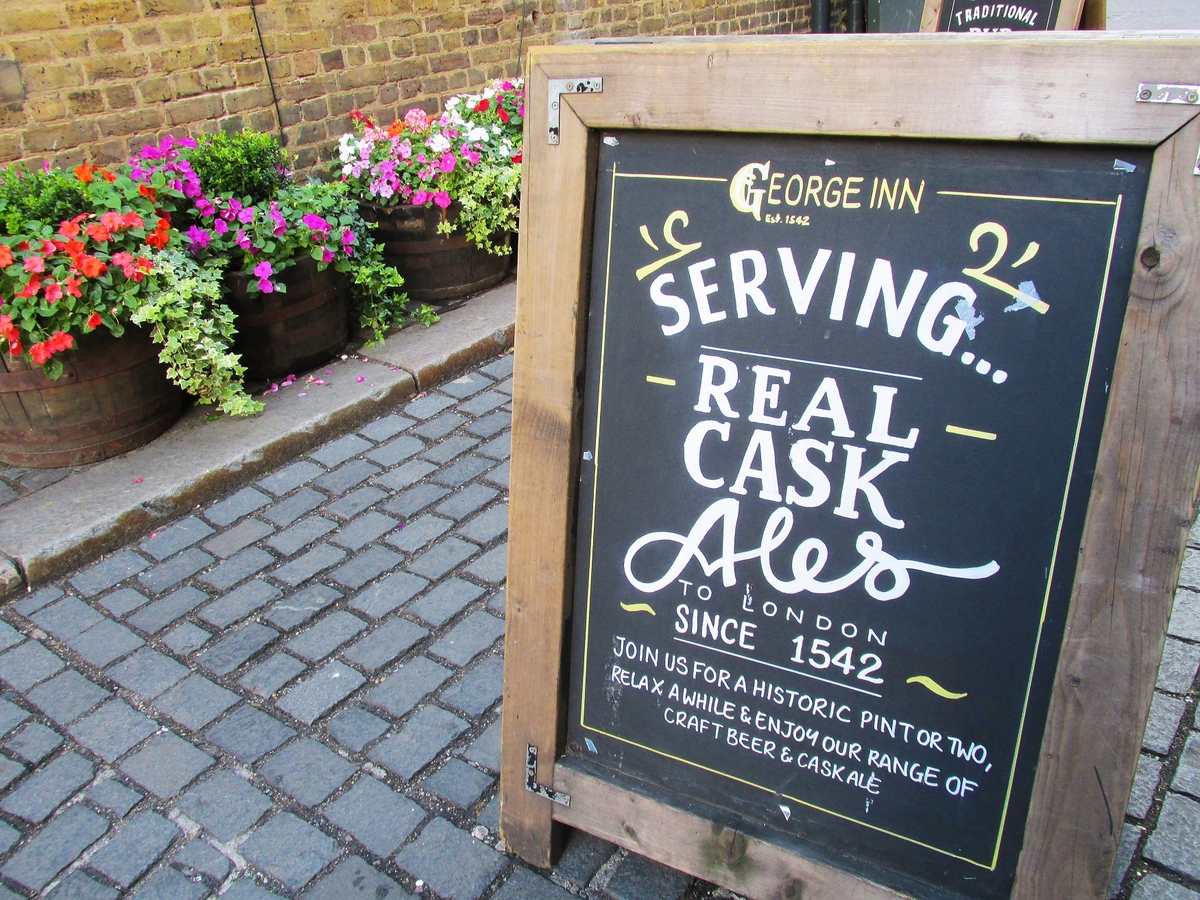 george inn bar sign in front of beautiful flowers